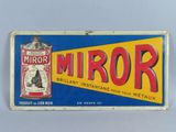 an old tin sign with a tin can of mirror on it