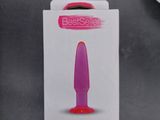 packaging of the small plug pink is on the table next to a pair of scissors and a pair of scissors