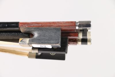 a close up of a violin bow and a bow rest