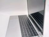 a close up of a laptop computer on a white surface