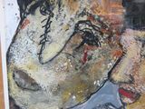 a painting of a man ' s face on the wall