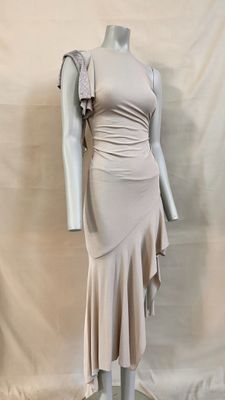 the mannequin is wearing a beige dress with ruffles on it