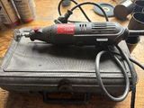 a small electric drill sitting on top of a hard case