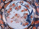 a plate with a bird on it on a table