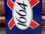 a blue sign with a red and white cross on it