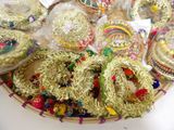 a basket full of gold and silver decorations on a table