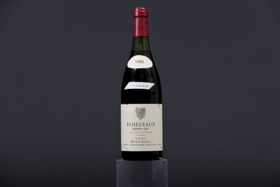 a bottle of wine sitting on top of a black table
