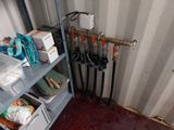 a room with a bunch of hoses and other items on the shelves