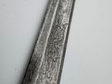 a close up of a spoon on a white table