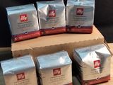 several packages of coffee sitting on top of a wooden table