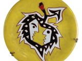 a yellow plate with a black and white design on it