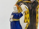 figurine of a woman holding a child in a blue dress