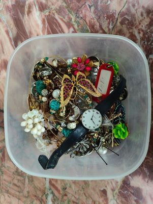 a plastic container filled with assorted items on a marble table