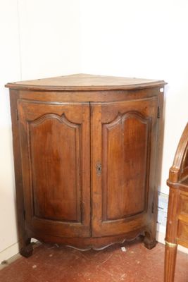 a corner cabinet in the corner of a room