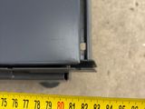 a measuring tape on the floor next to a black box