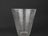 a close up of a clear glass cup on a black background