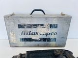 an old tool box and a drill on a table