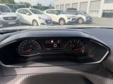a dashboard of a car in a parking lot with cars in the background