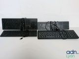 two keyboards and a mouse sitting on a table
