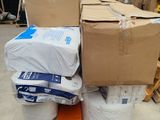 many boxes of toilet paper on a pallet in a warehouse
