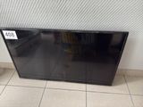 a picture of a flat screen tv sitting on a tiled floor