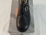 a black shoe that is sitting on top of a box