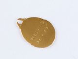 a close up of a gold medal on a white surface