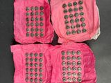 three pink cell phones sitting on top of each other on top of a table