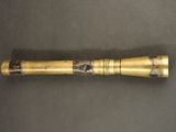 an image of a gold baseball bat on a table