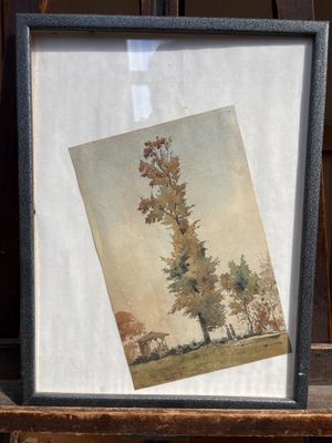 une image représentant un tableau représentant un arbre, dans un cadre posé sur une chaise