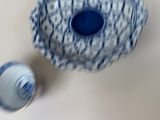 a blue and white bowl and a blue and white cup on a table