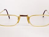 pair of glasses on a white surface with a white background