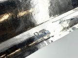 a close up of a silver plate with a knife in it