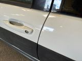 a close up of a car door handle with a black and white stripe