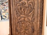 a large carved wooden door in the corner of a room