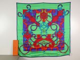 green, red, and blue silk scarf hanging on a wall