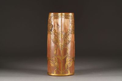 a brown vase with a gold design on it