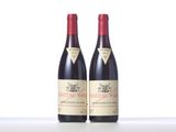 two bottles of red wine sitting next to each other on a table