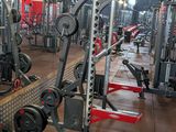 a gym with a lot of machines in the room