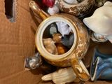 a box full of teapots and other items