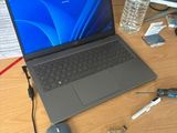 a laptop computer sitting on a desk next to a mouse
