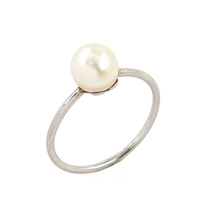 a close up of a pearl ring on a white background