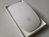 a white apple mouse in a white box on a table