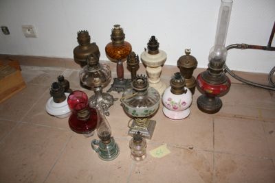 many different types of antique lamps on the floor