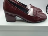 a close up of a pair of red shoes on a white box