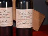 two bottles of red wine sitting on a table