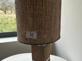 a lamp that is sitting on a table by a window