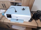 a printer sitting on top of a desk next to a coffee pot
