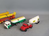 several toy trucks are lined up on a gray surface