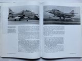 a book opened to show a picture of a fighter jet